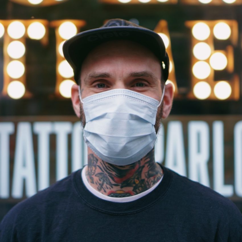 Tattoo Artist wears face mask